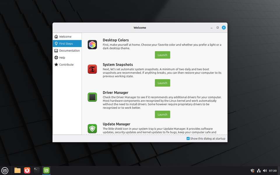 First Steps on the Welcome Screen. The shield beside the clock opens the Update Manager.